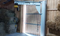 Slewing pillar crane is used to transport goods in the barn