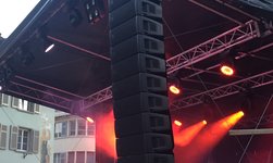 Electric chain hoist carries loudspeaker tower outdoor stage