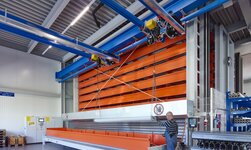 GISKB double girder suspension crane with electric chain hoist on saddle GISKB crane with parallel crane bridges lifts long, bulky metal pieces