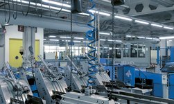 In a printing plant, rolls of paper are lifted with a synchronous chain hoist