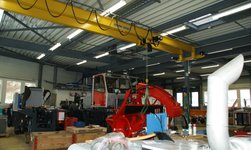 Overhead crane transports components for vehicle construction