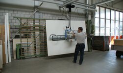 Vacuum handling system GN Vacuum lifter lifts and turns wooden board