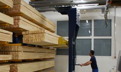 Wooden beams are lifted into the rack with a crane system