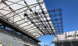 Electric chain hoists carry truss under stadium roof